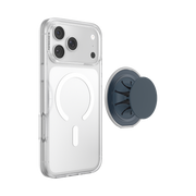 Expanded navy PopSockets Low-Pro grip beside an iPhone in a clear MagSafe case, illustrating magnetic attachment.